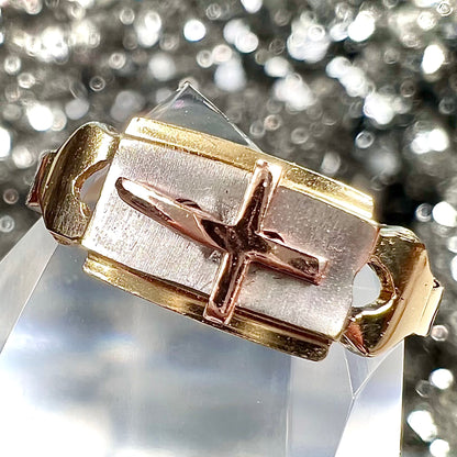 A tricolor gold cross ring handmade from rose, white, and yellow gold.