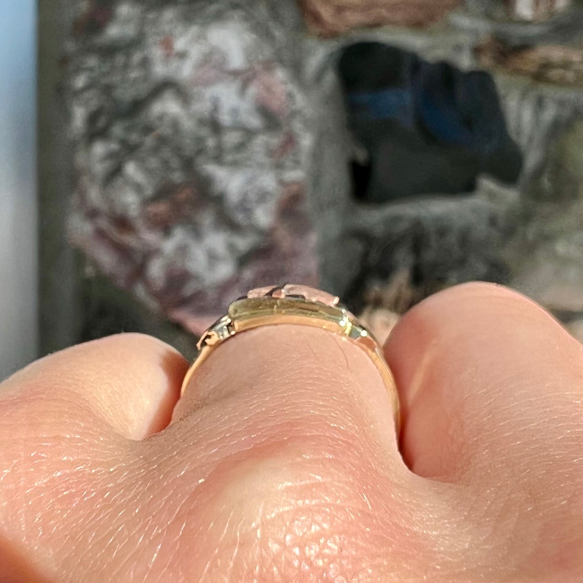 A tricolor gold cross ring handmade from rose, white, and yellow gold.
