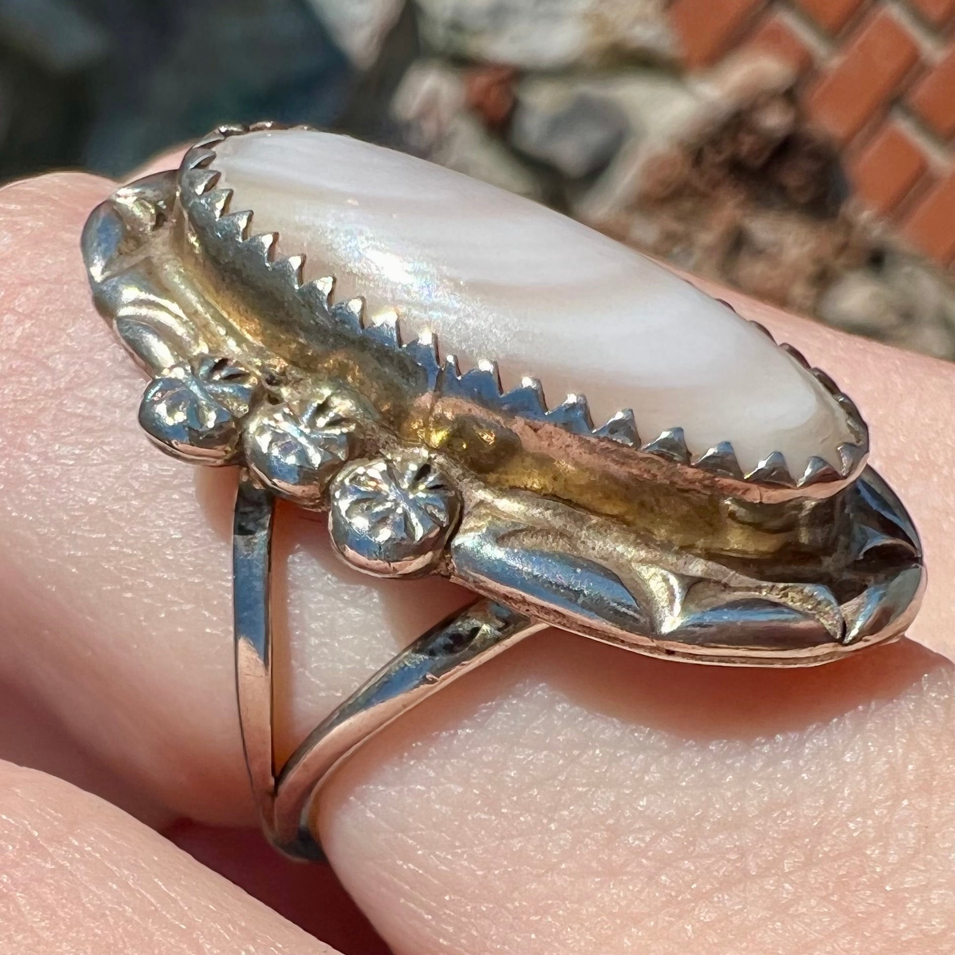 A Southwest style silver ring set with a faint pink mother of pearl stone.