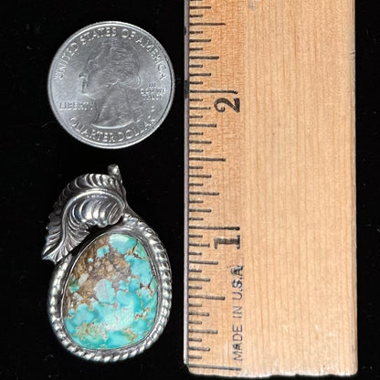 A handmade silver Navajo style pendant set with a turquoise stone from Kingman, Arizona.
