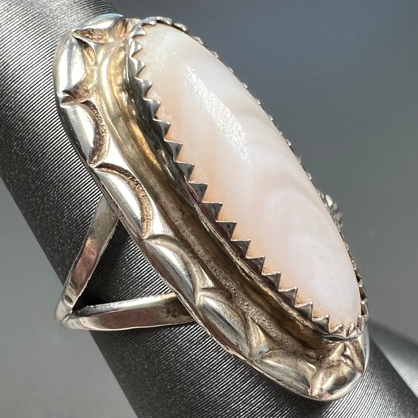 A Southwest style silver ring set with a faint pink mother of pearl stone.