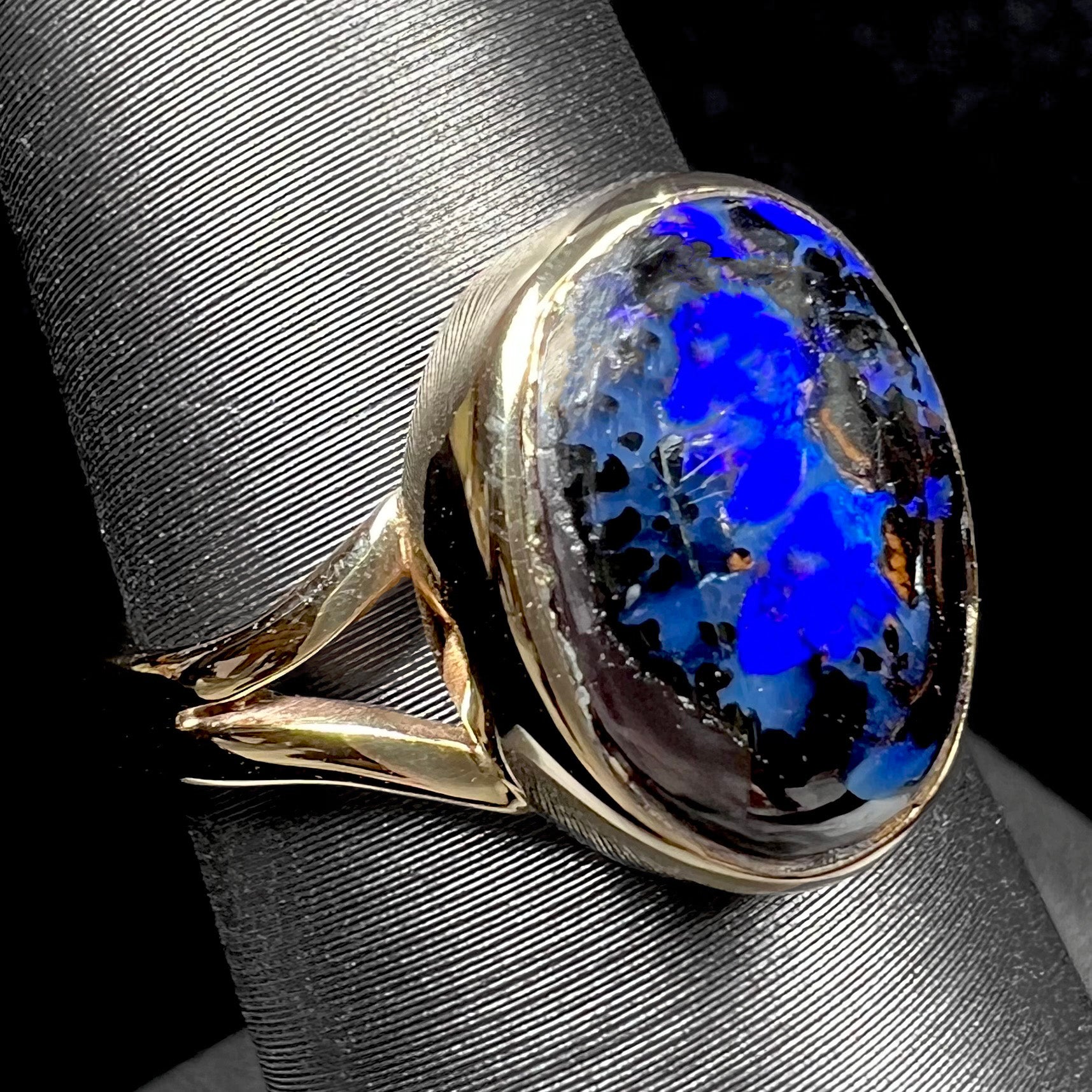 A handmade ladies' yellow gold boulder opal ring.  The opal is a natural purple Yowah nut boulder opal.