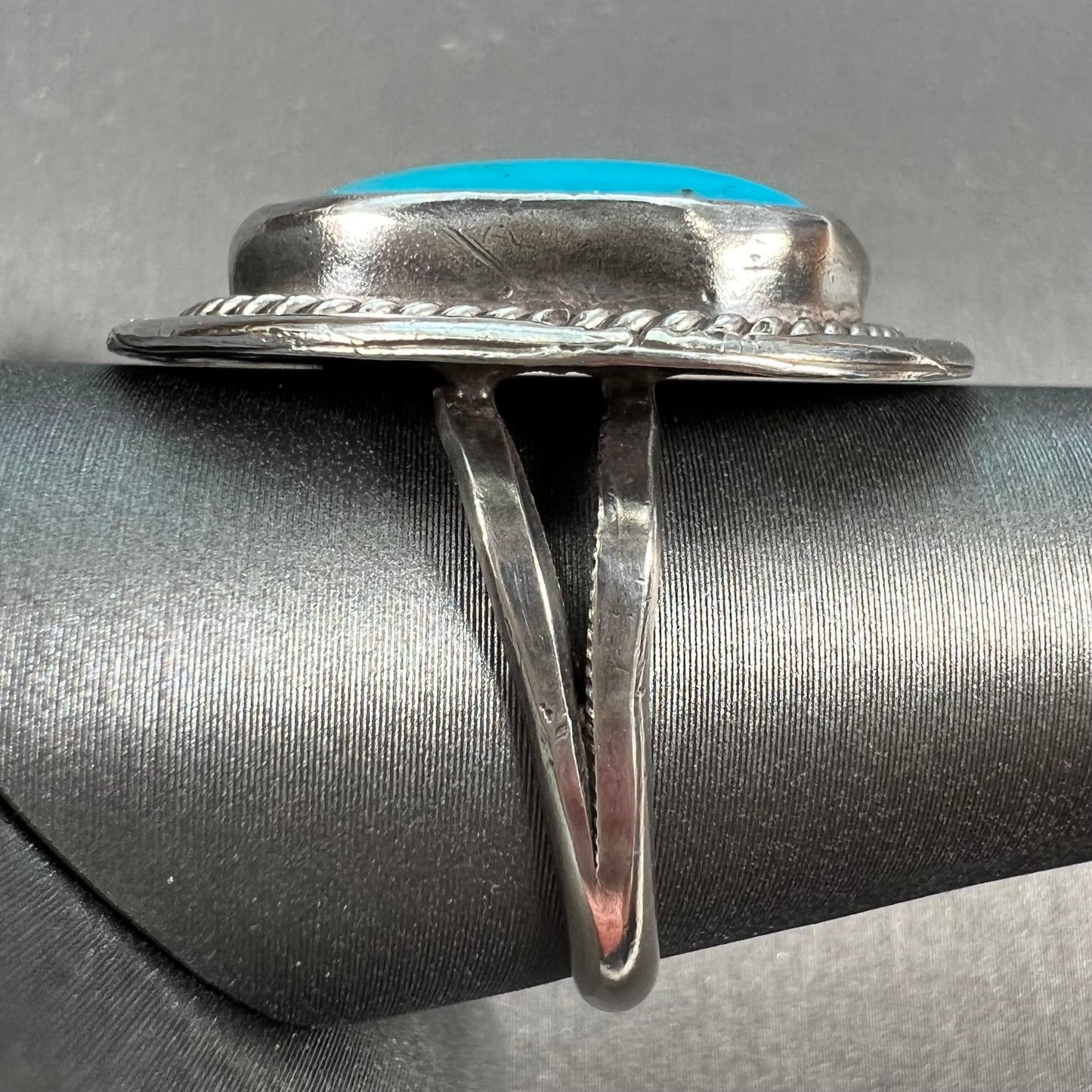 A men's silver, handmade, Navajo turquoise ring.