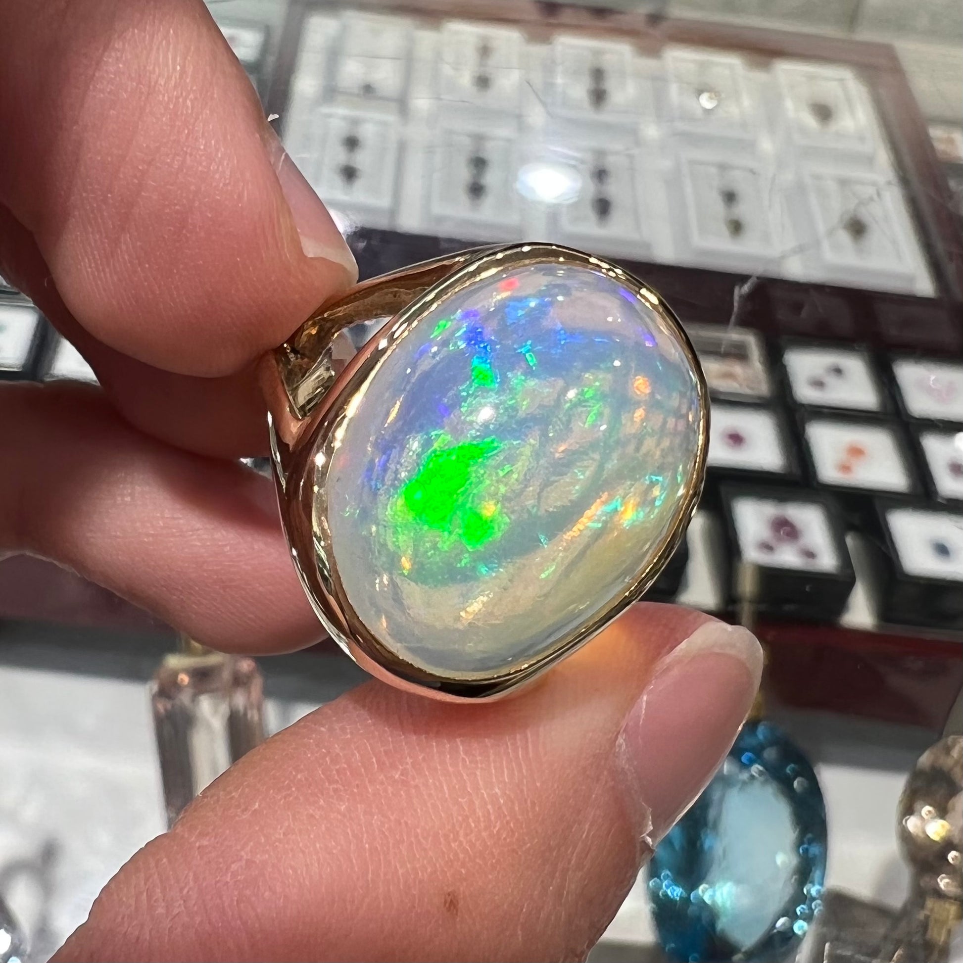 A gold split shank solitaire ring set with an oval cabochon cut 16.83 carat Ethiopian jelly fire opal.