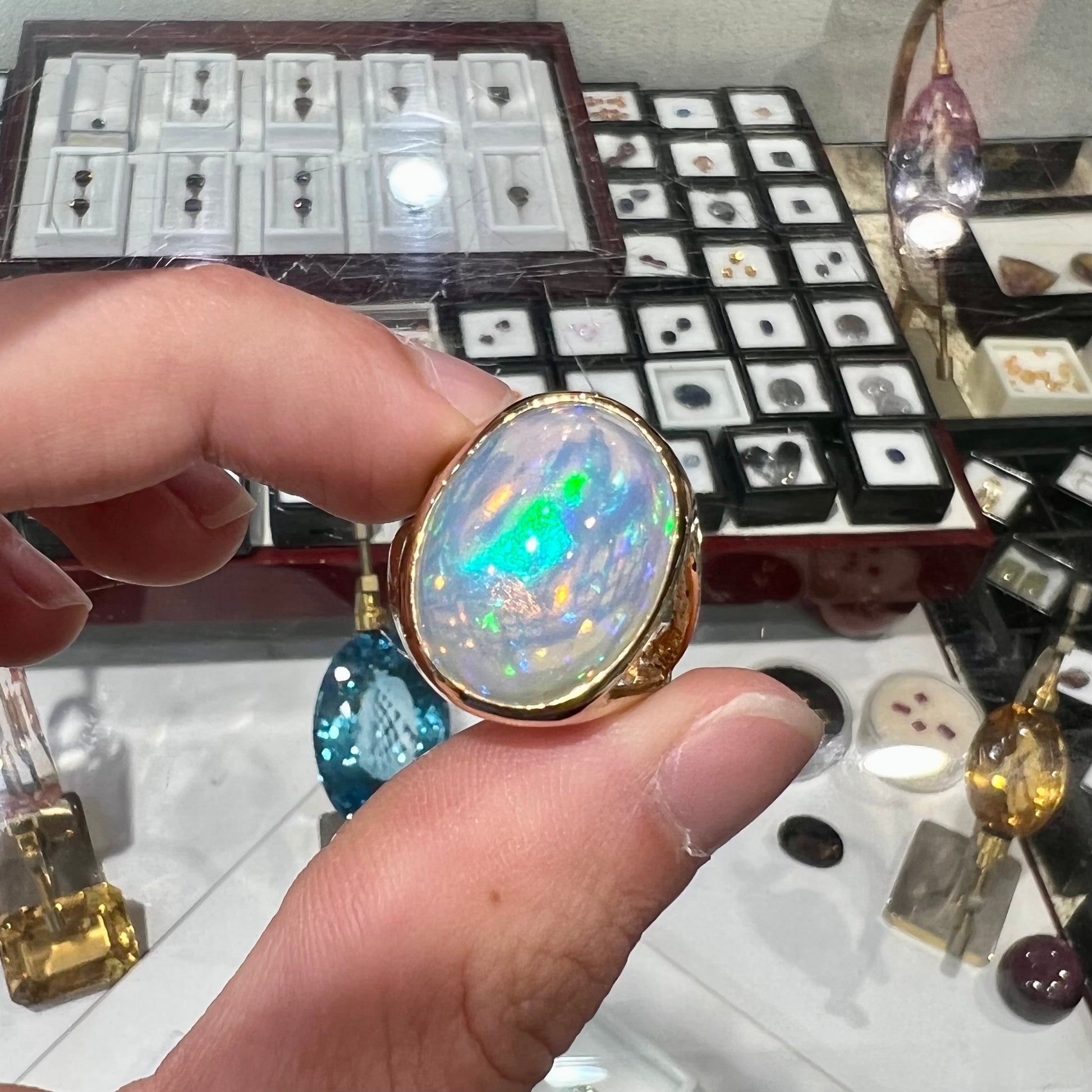 A gold split shank solitaire ring set with an oval cabochon cut 16.83 carat Ethiopian jelly fire opal.