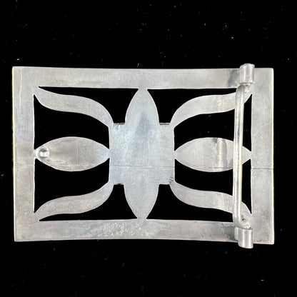 A handmade, Navajo style, sterling silver belt buckle set with a rectangular cabochon cut blue turquoise.