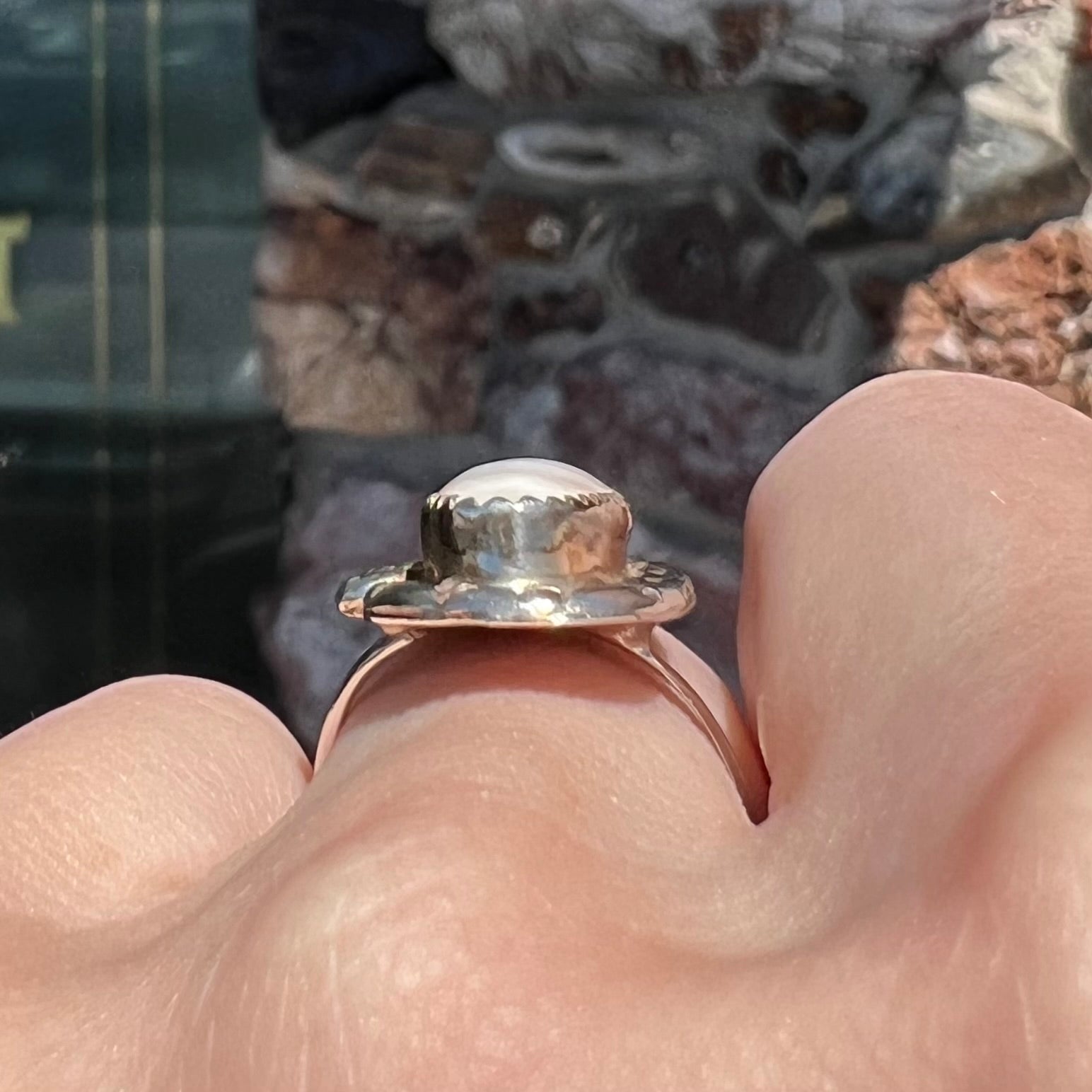 A Southwest style silver ring set with a faint pink mother of pearl stone.