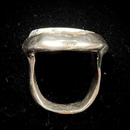 A bezel set ring handmade in sterling silver with a white dendritic agate stone.