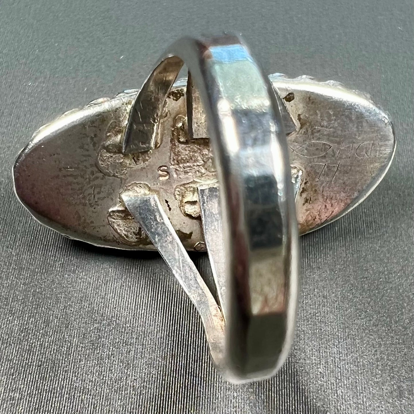 A split shank silver ring set with a brown sard stone in a rope bezel with small prongs.