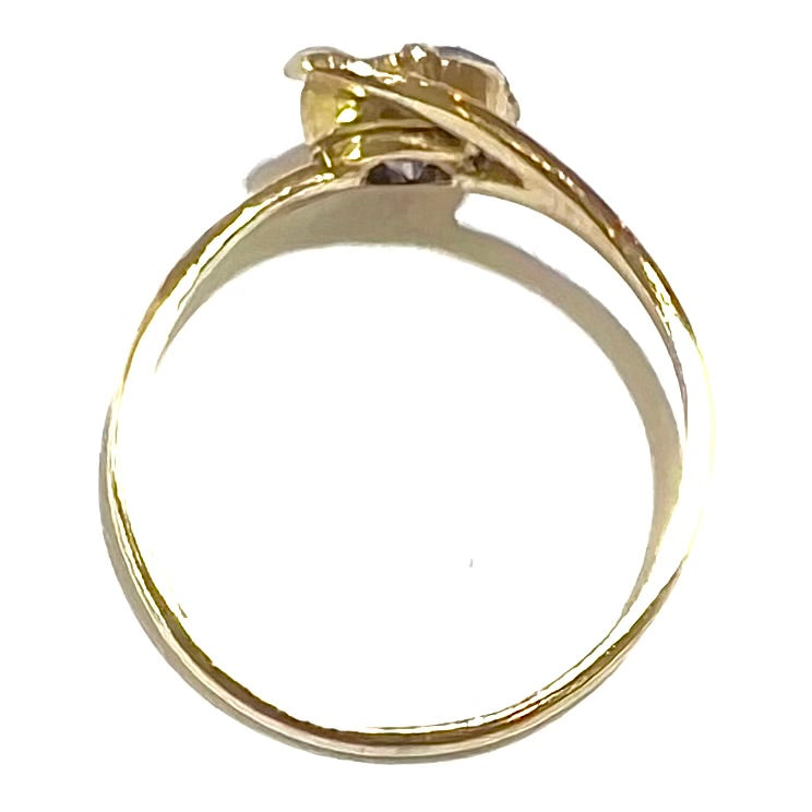 A vintage 1960's yellow gold ring set with a round synthetic purple alexandrite.  The prongs are worn.