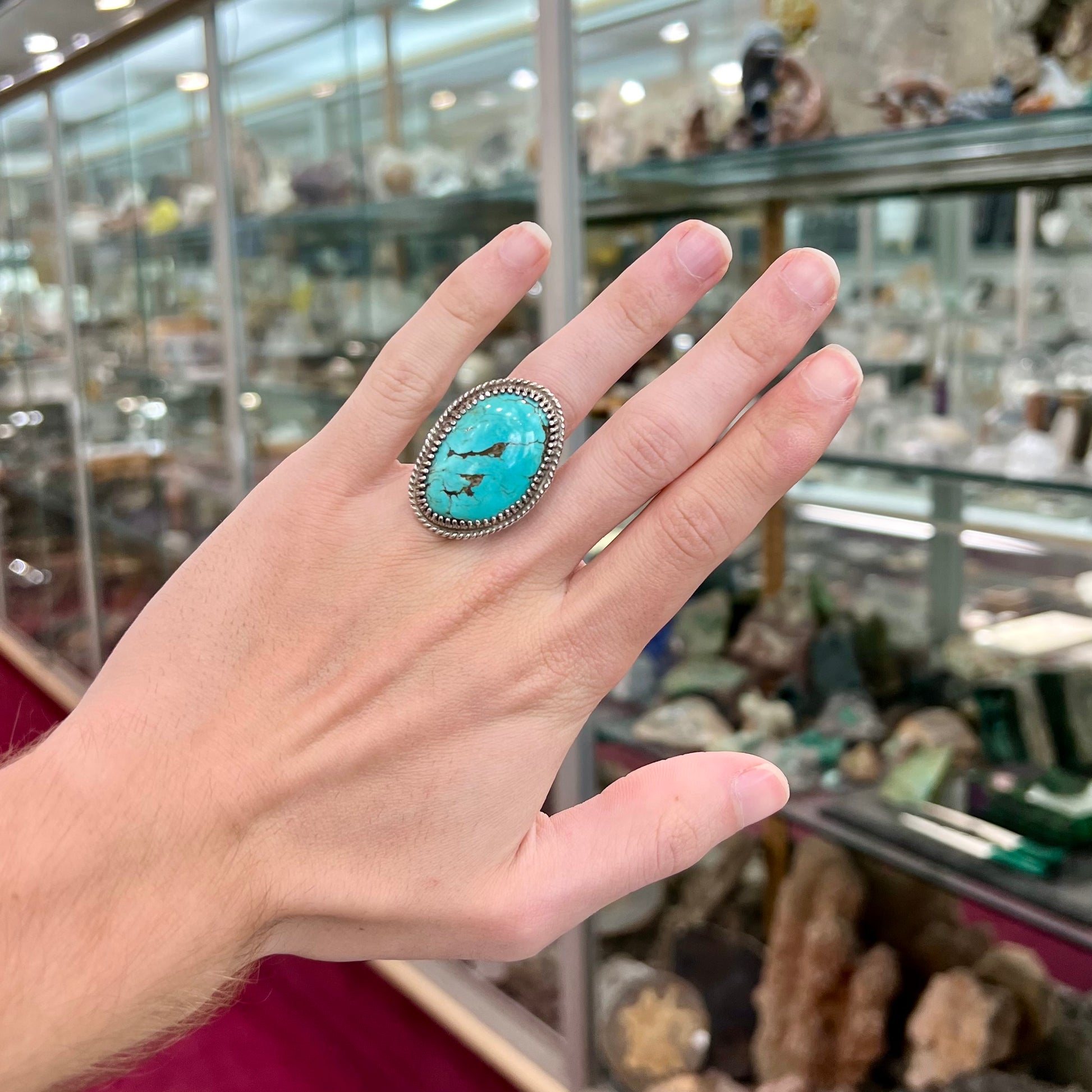 A sterling silver rope design ring set with a turquoise stone from Pilot Mountain Mine, Nevada.
