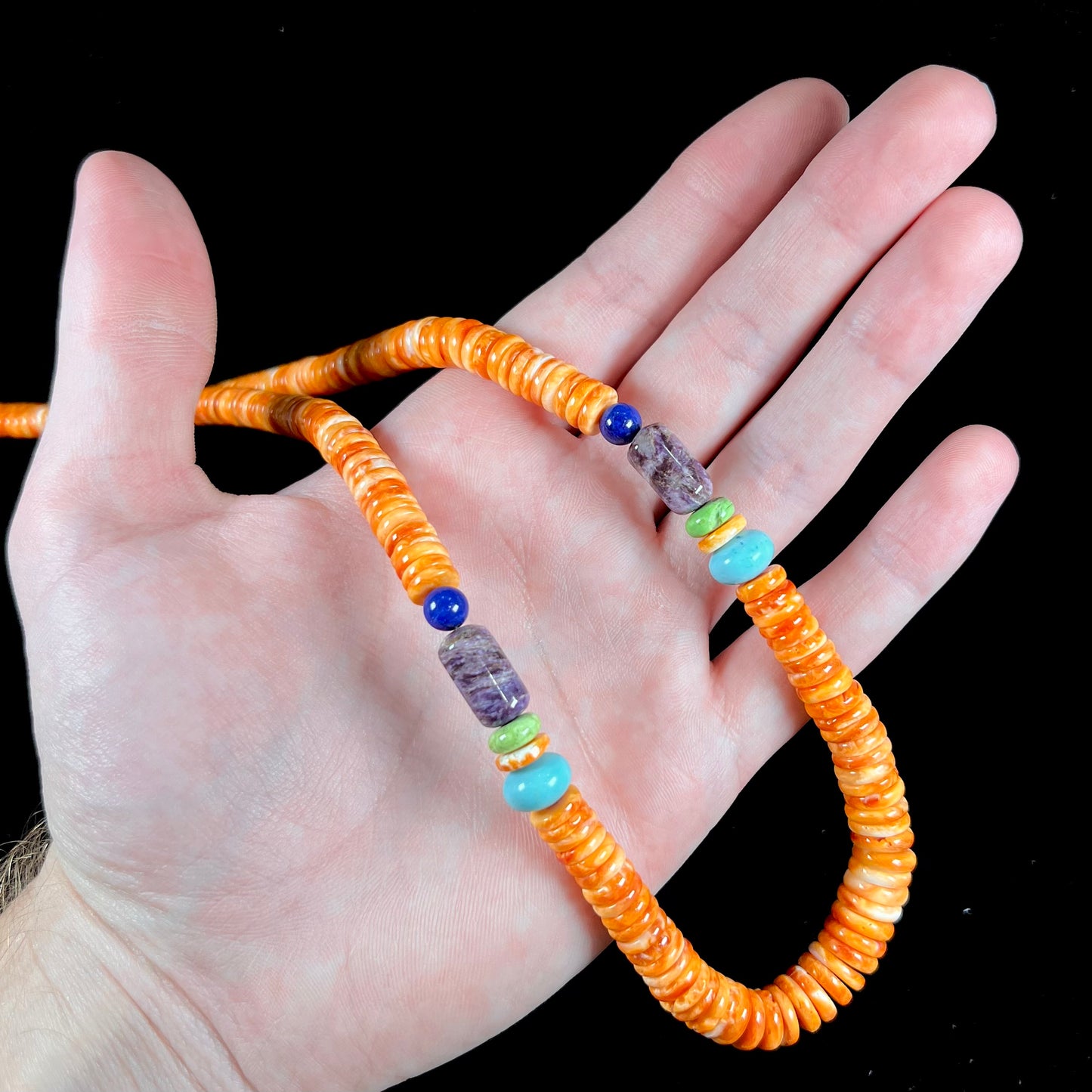 A heishi Santo Domingo bead necklace made from polished spiny oyster, turquoise, gaspeite, charoite, and lapis lazuli.