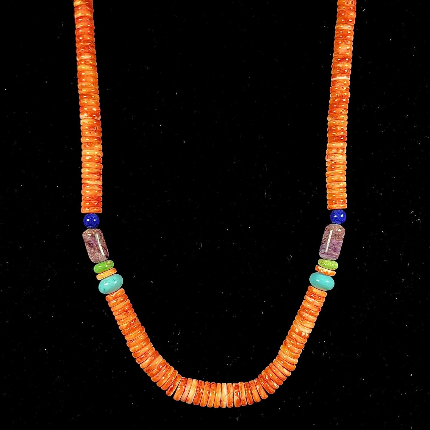 A heishi Santo Domingo bead necklace made from polished spiny oyster, turquoise, gaspeite, charoite, and lapis lazuli.