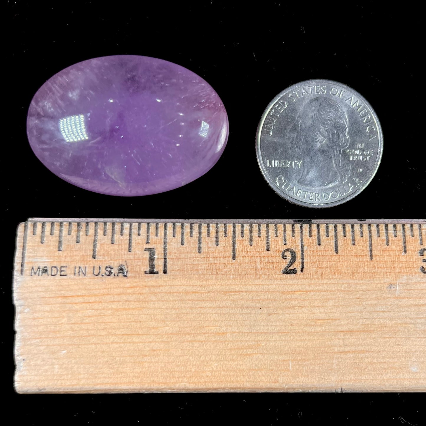 A cabochon cut red amethyst stone from Mexico.  The piece shows a faint star.