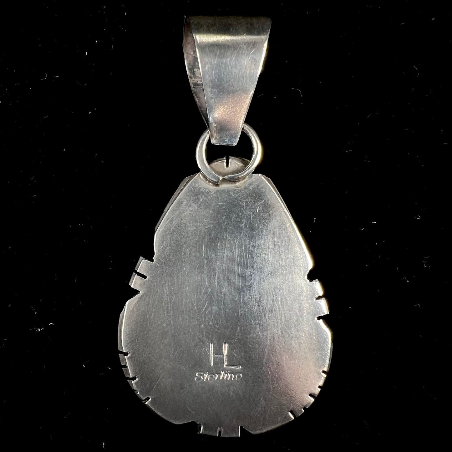 A sterling silver bezel set variscite stone pendant handmade by Navajo artist, Herman Lee.