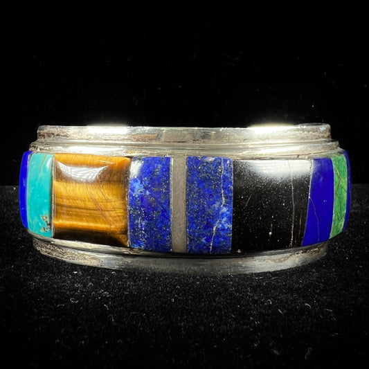 A men's vintage sterling silver Hopi Indian cuff bracelet set with tiger's eye, lapis lazuli, turquoise, jet, and rhodonite.