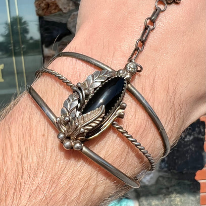 A sterling silver Hopi style onyx slave bracelet and ring set.