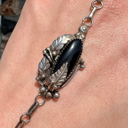A sterling silver Hopi style onyx slave bracelet and ring set.