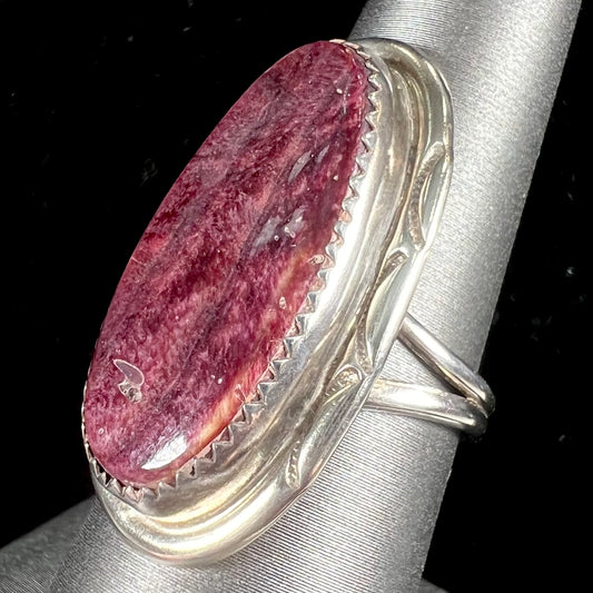 A sterling silver ring set with a purple spiny oyster shell, handmade by the Hopi Indian artist.