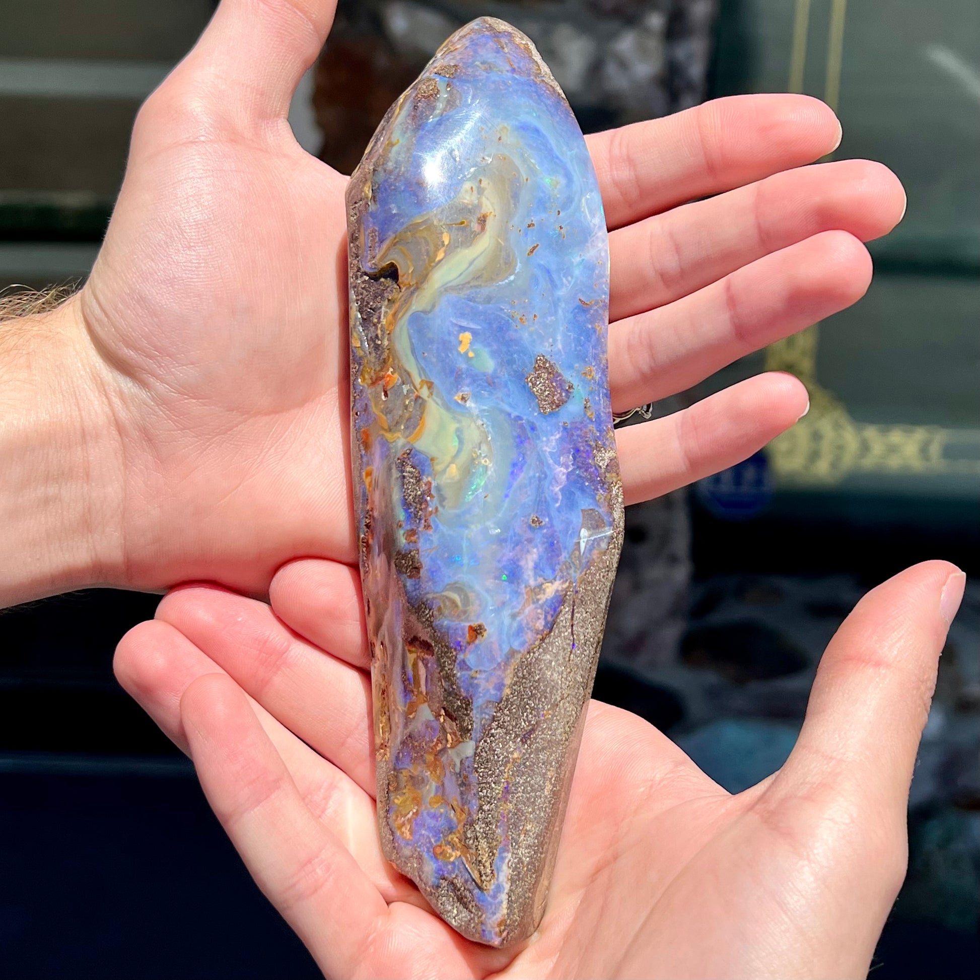 A 7 inch long polished blue Quilpie boulder opal specimen from Queensland, Australia.