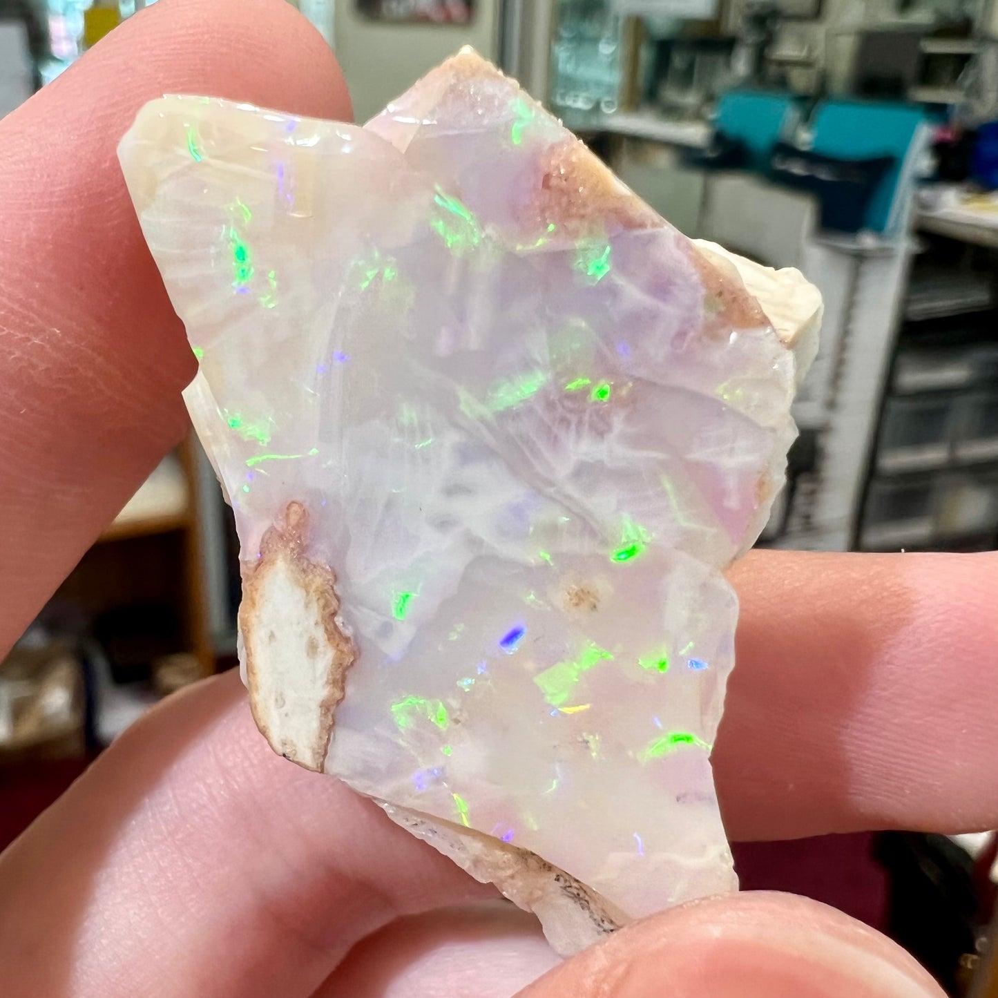 A loose, polished specimen of white crystal opal from Spencer, Idaho, USA.