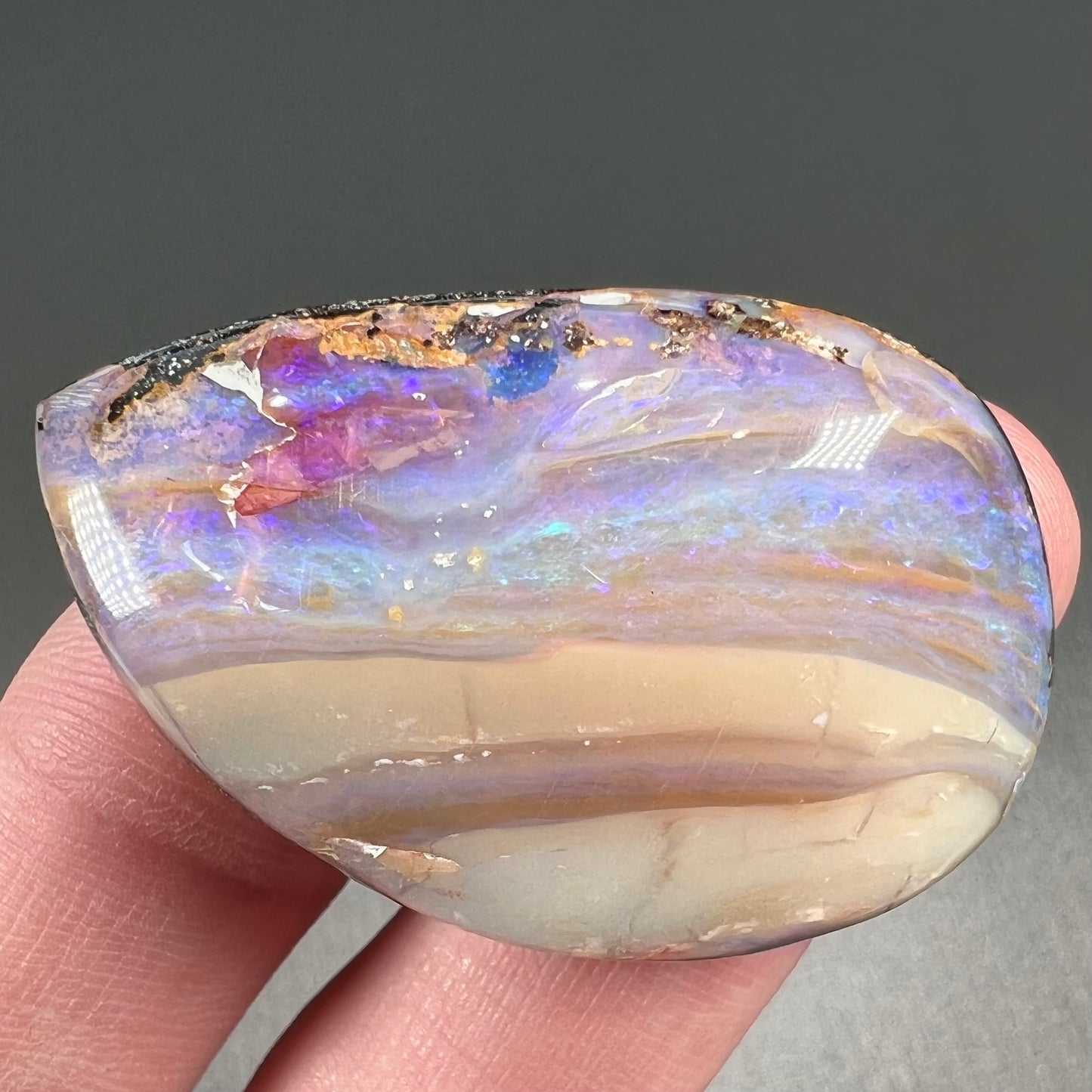 A loose, drop shaped Australian boulder opal from Quilpie Mining District.