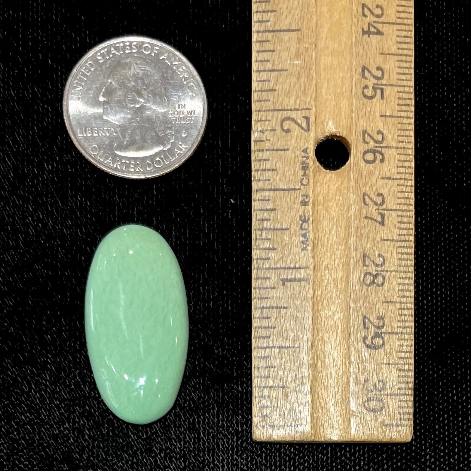 A loose, oval cabochon cut variscite stone from Utah, USA.