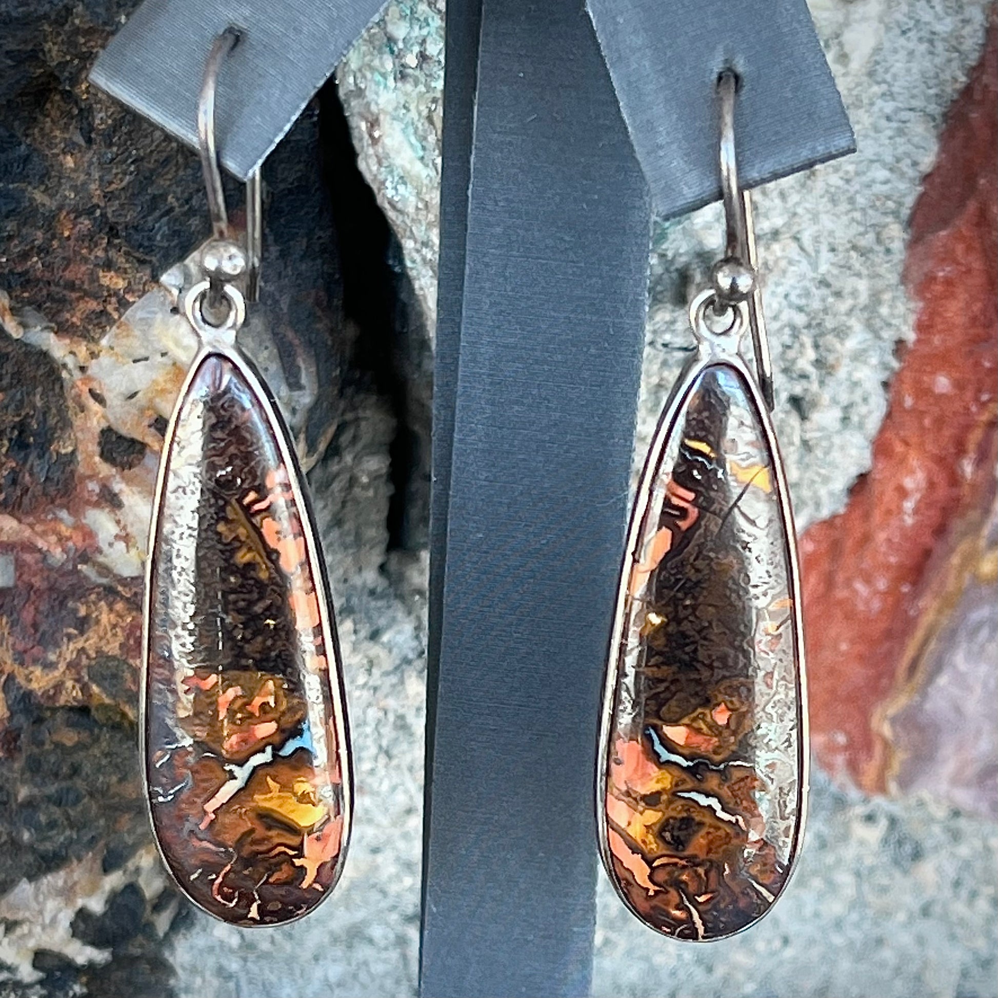 A pair of sterling silver boulder opal drop dangle earrings.