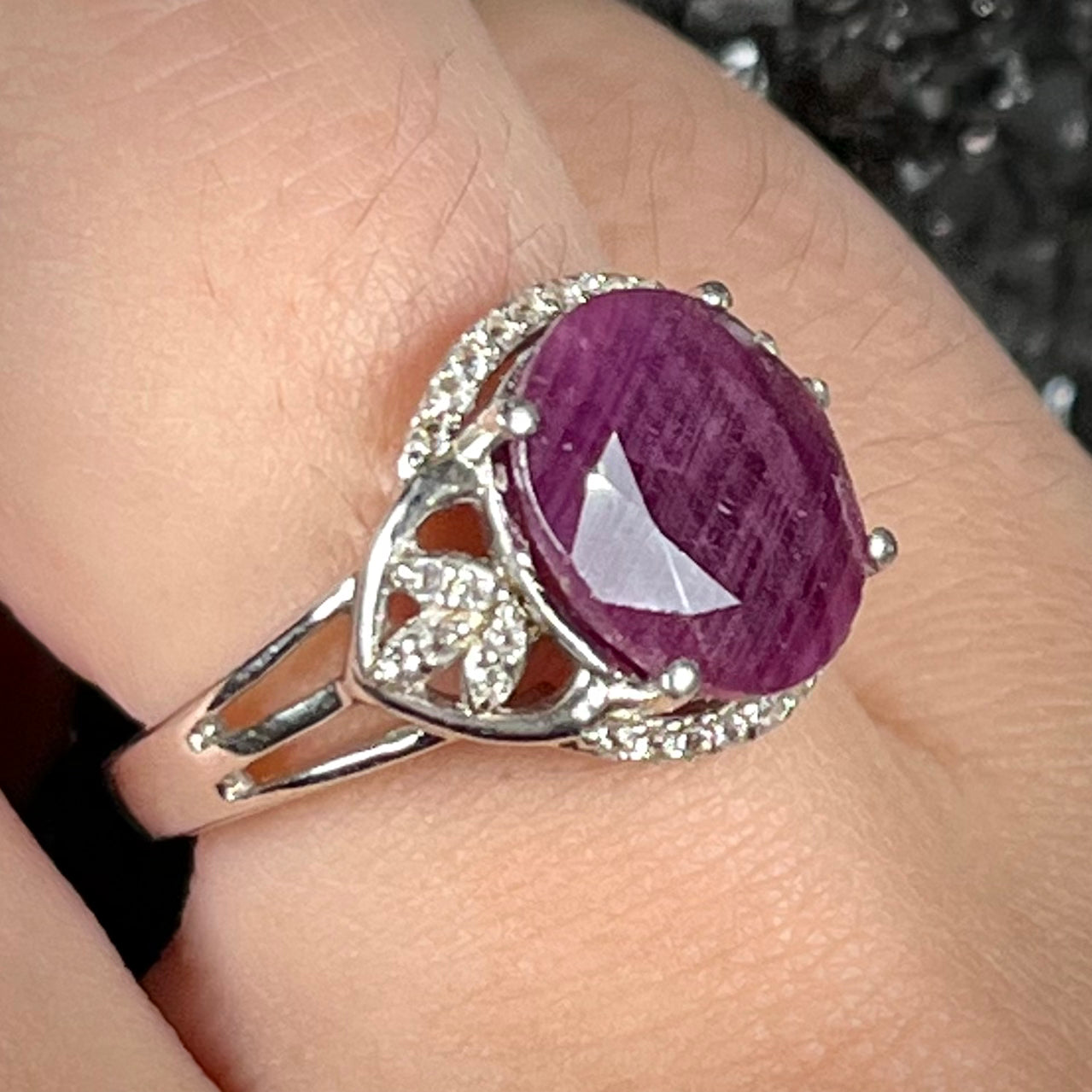 An oval cut natural ruby set in a sterling silver ring.