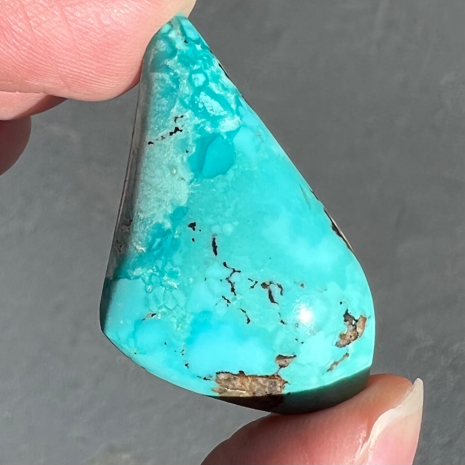 A loose, drop shape turquoise stone from the Sleeping Beauty Mine.