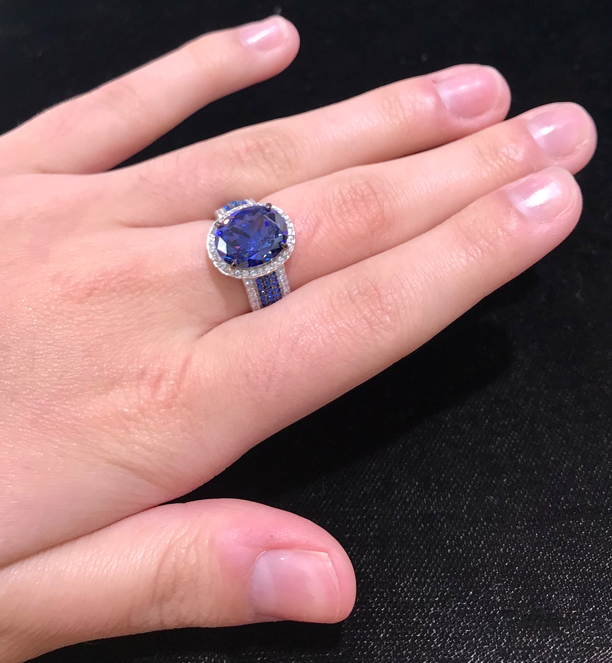 Synthetic blue and white gemstone ring prong set in sterling silver.