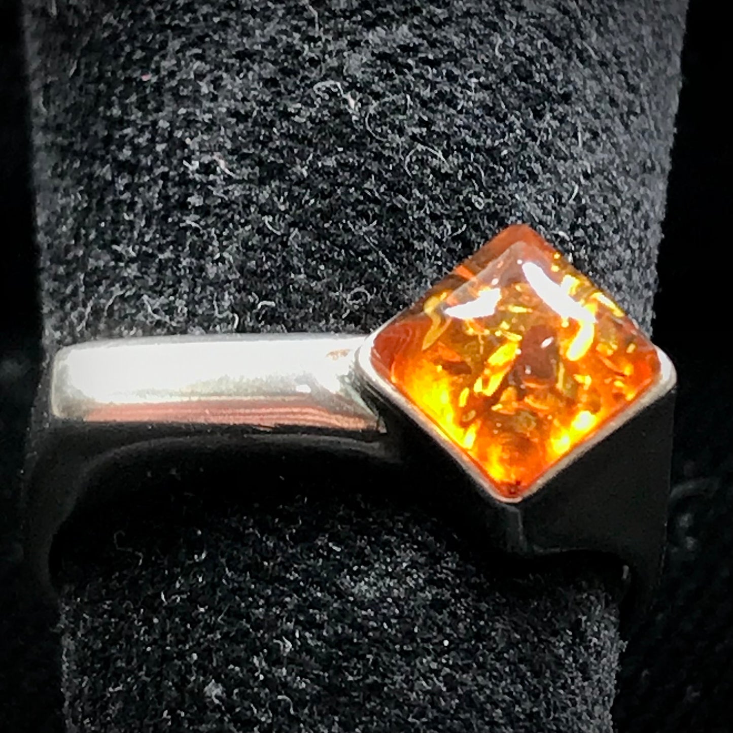Square shaped Baltic Amber cabochon set in a unique sterling silver ring.