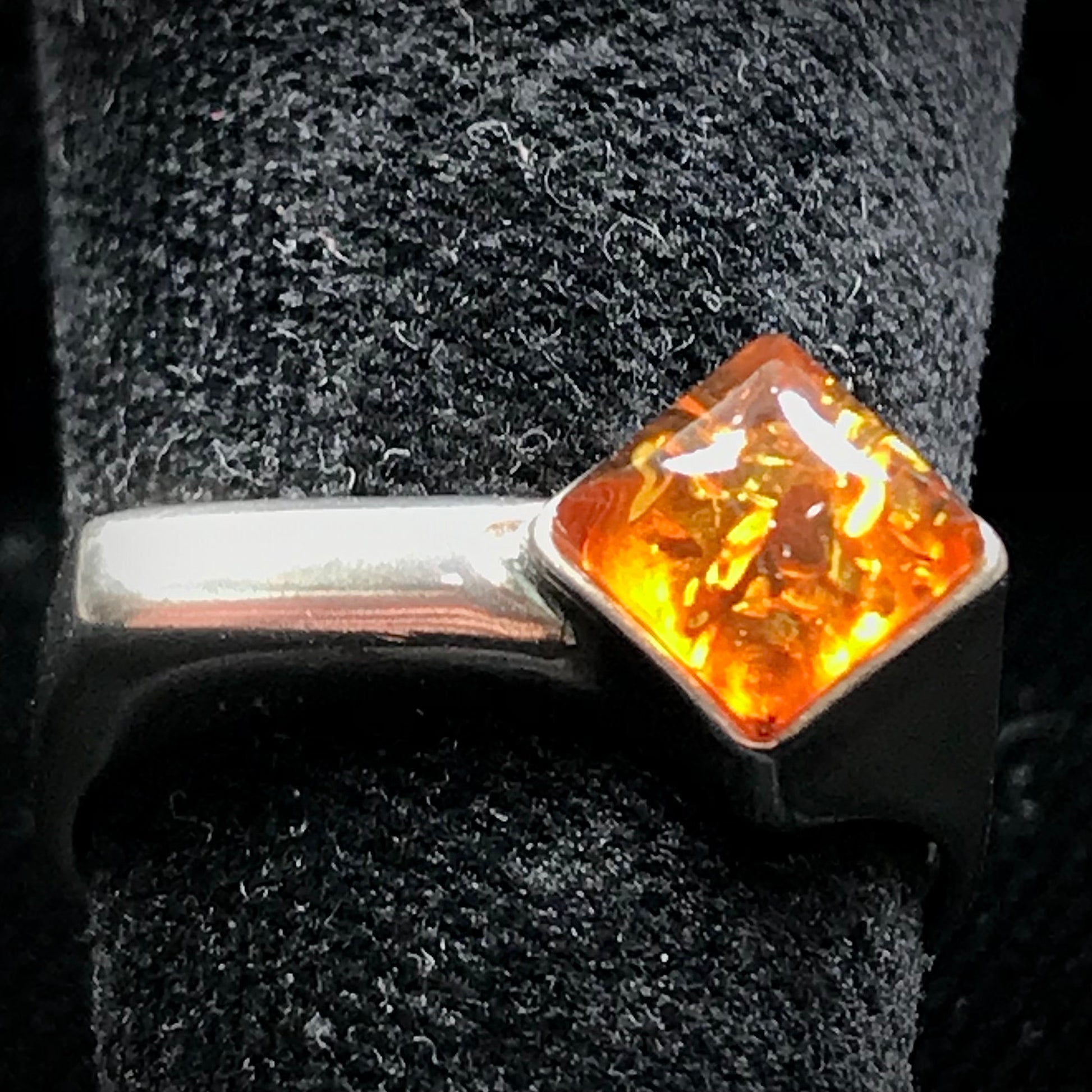 Square shaped Baltic Amber cabochon set in a unique sterling silver ring.