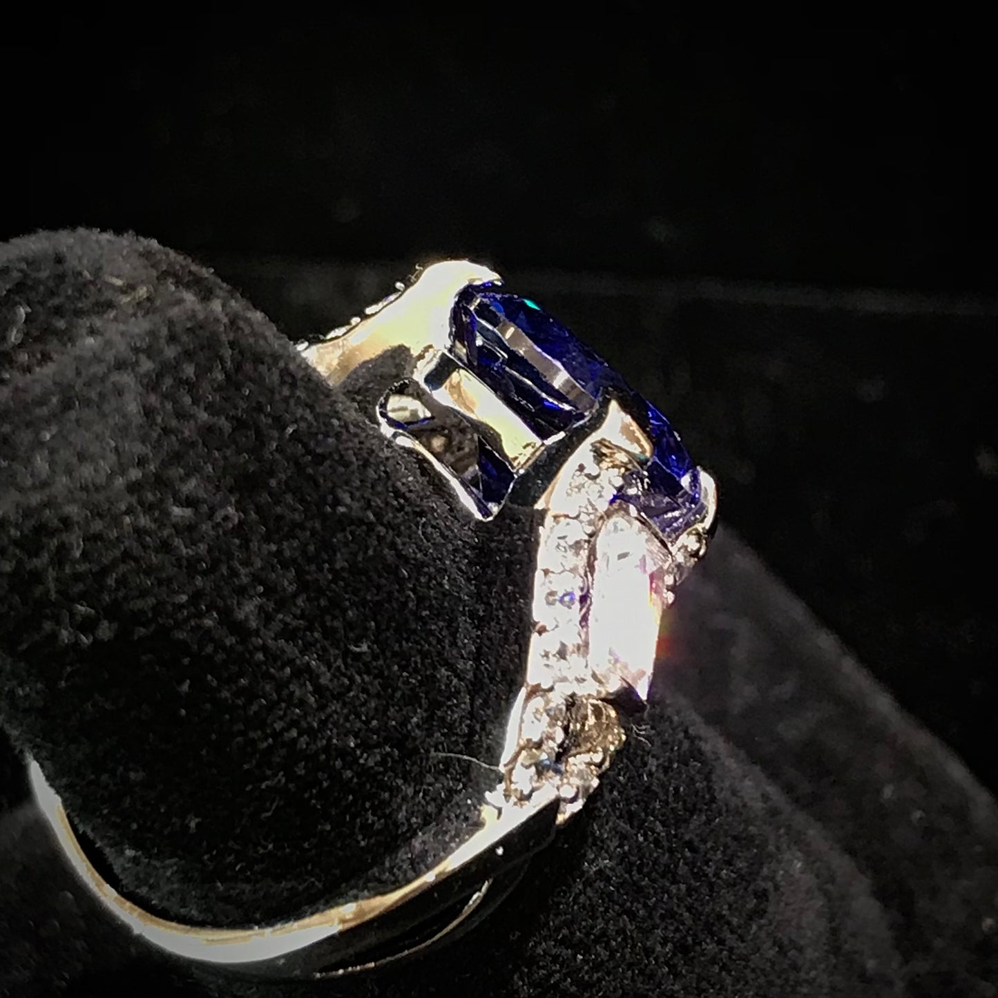 Dark blue synthetic gemstone and cubic zirconia set in sterling silver.