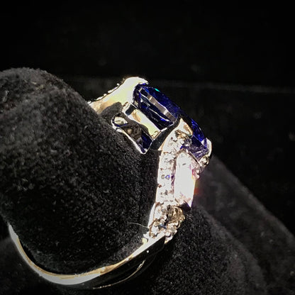 Dark blue synthetic gemstone and cubic zirconia set in sterling silver.