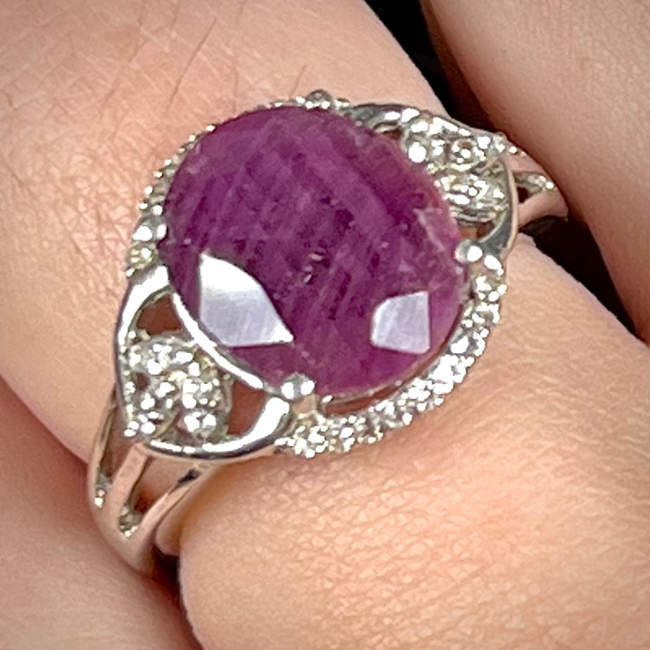An oval cut natural ruby set in a sterling silver ring.