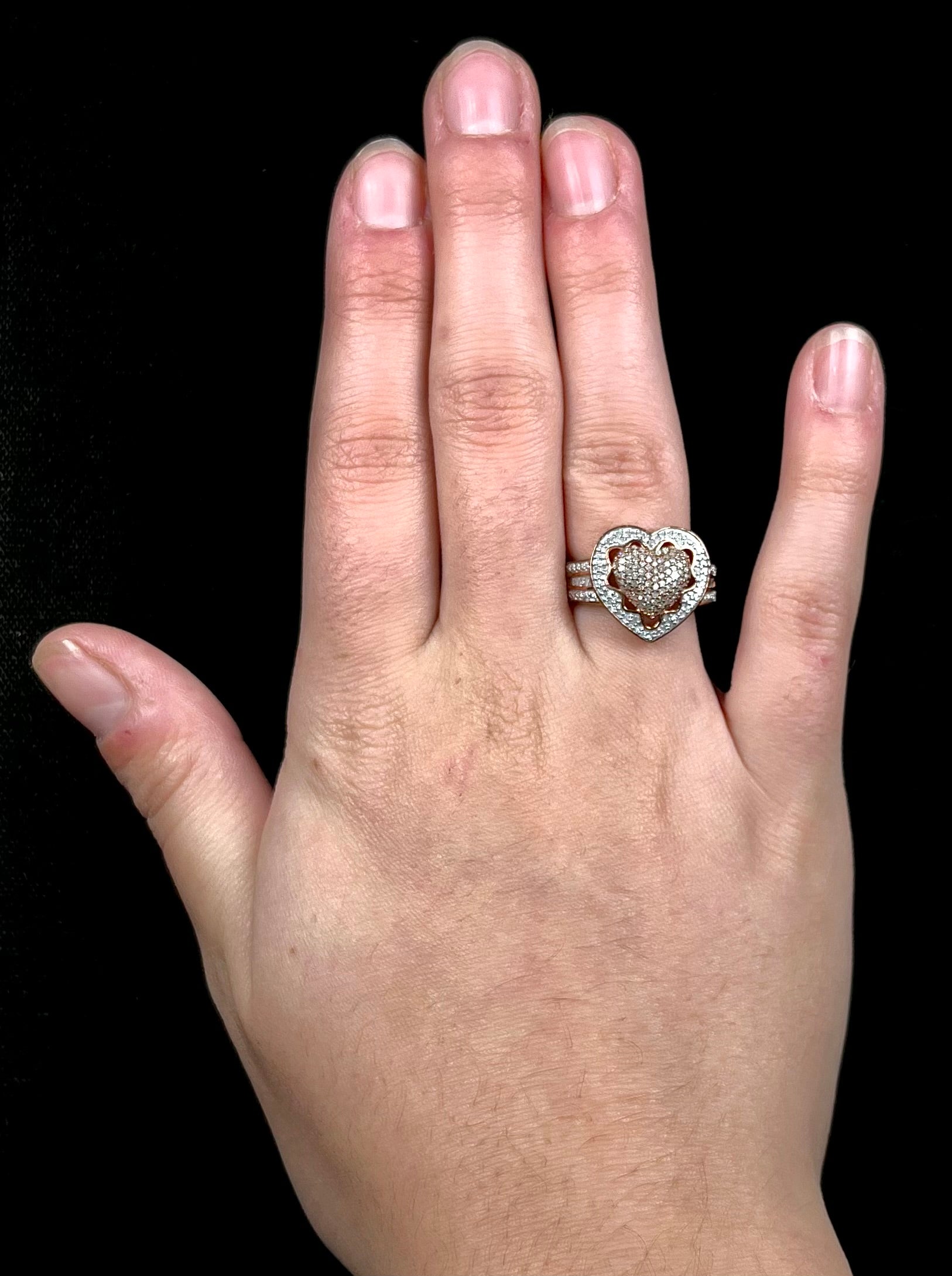 A rose colored metal ring pavé set with round and baguette cut diamonds.