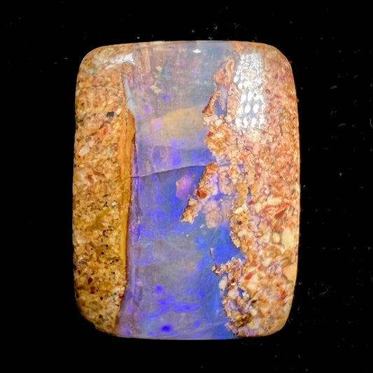 A polished, drilled pipe boulder opal bead.