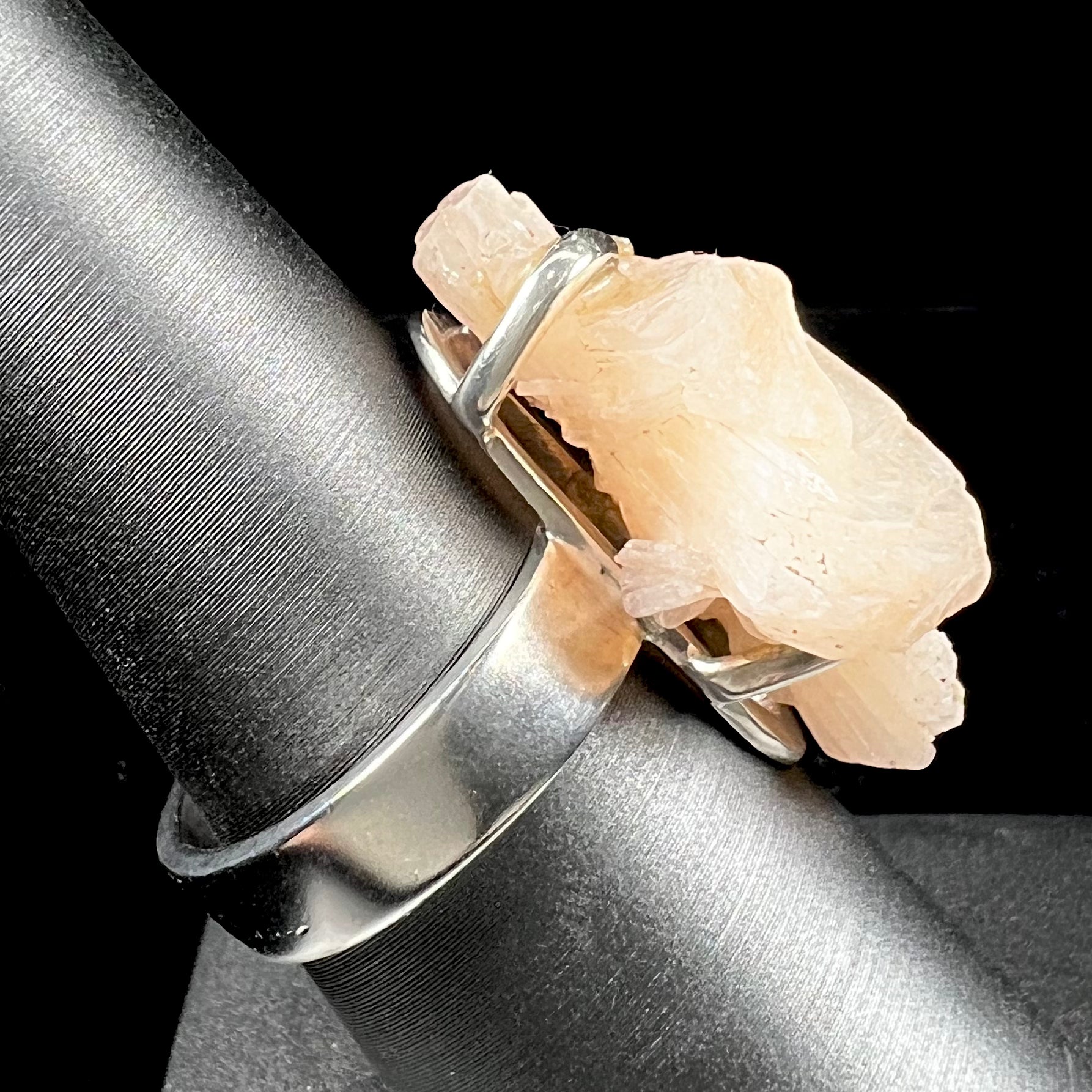 A sterling silver ring prong-set with a twinned moonstone crystal.