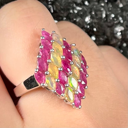 A silver ring set with a cluster of marquise cut rubies and orange Ethiopian fire opals.