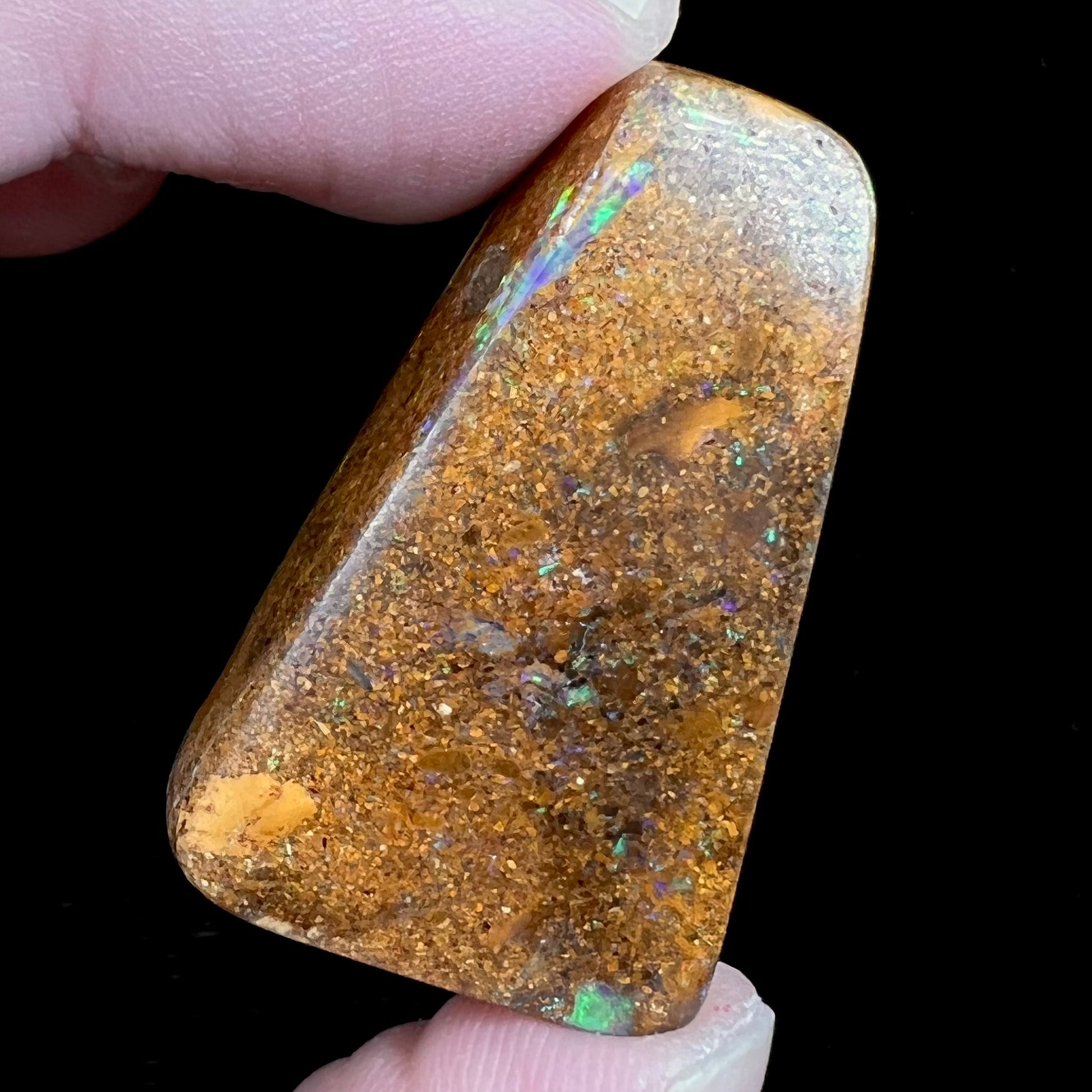 A polished, drilled pipe boulder opal bead.