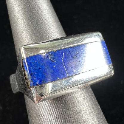 A sterling silver ring inlaid with a piece of lapis lazuli.  A small crack runs through the piece of lapis.