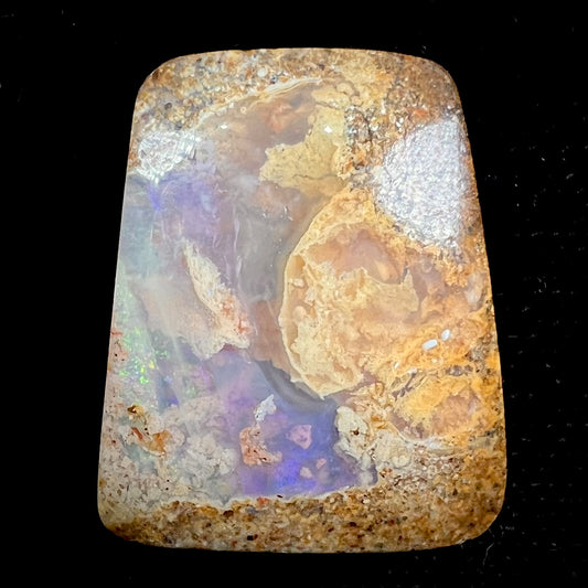 A polished, drilled pipe boulder opal bead.