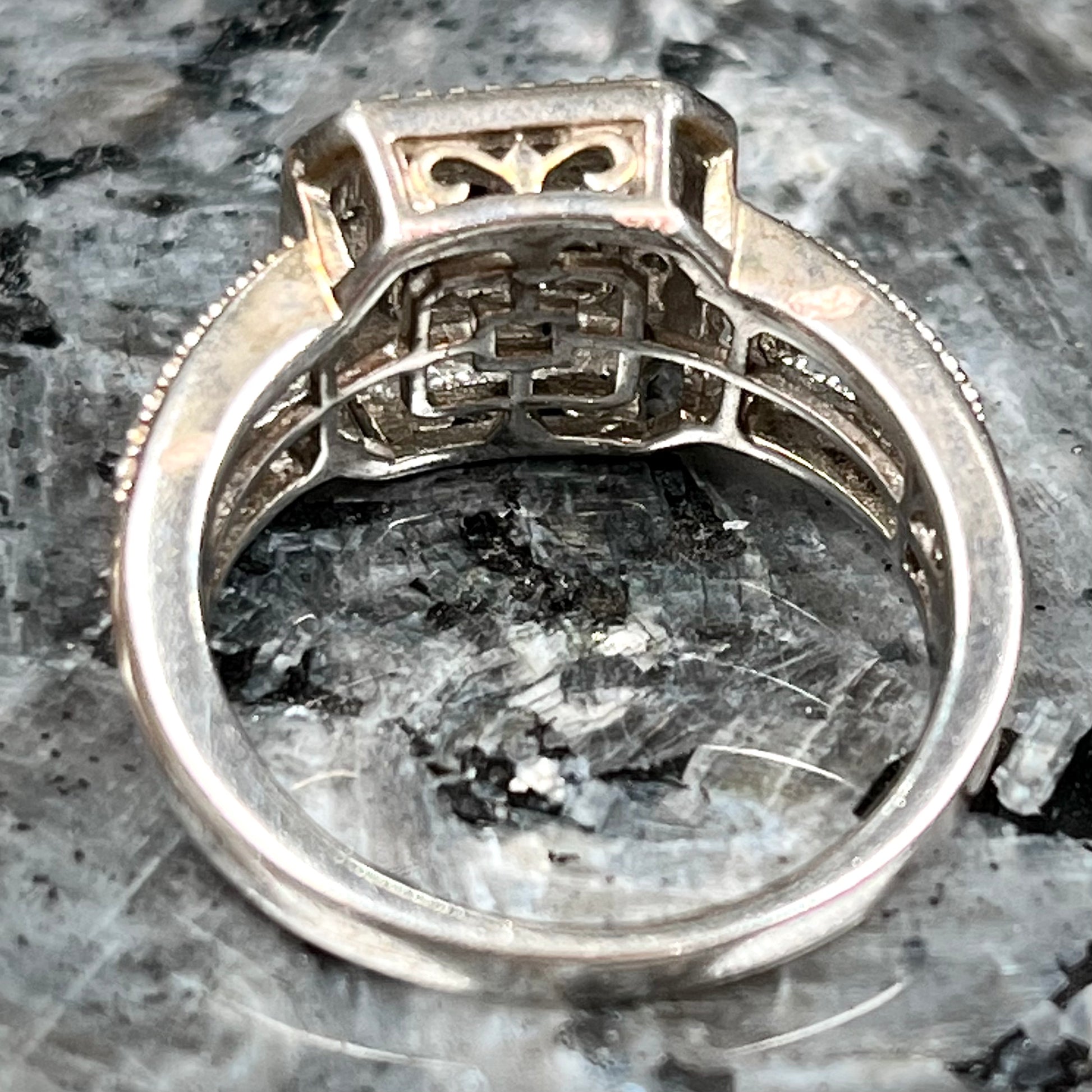 A sterling silver ring set with blue and white diamonds.
