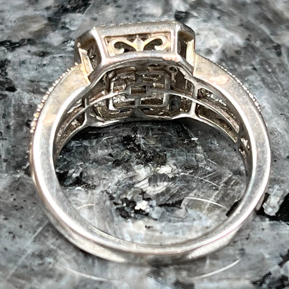 A sterling silver ring set with blue and white diamonds.