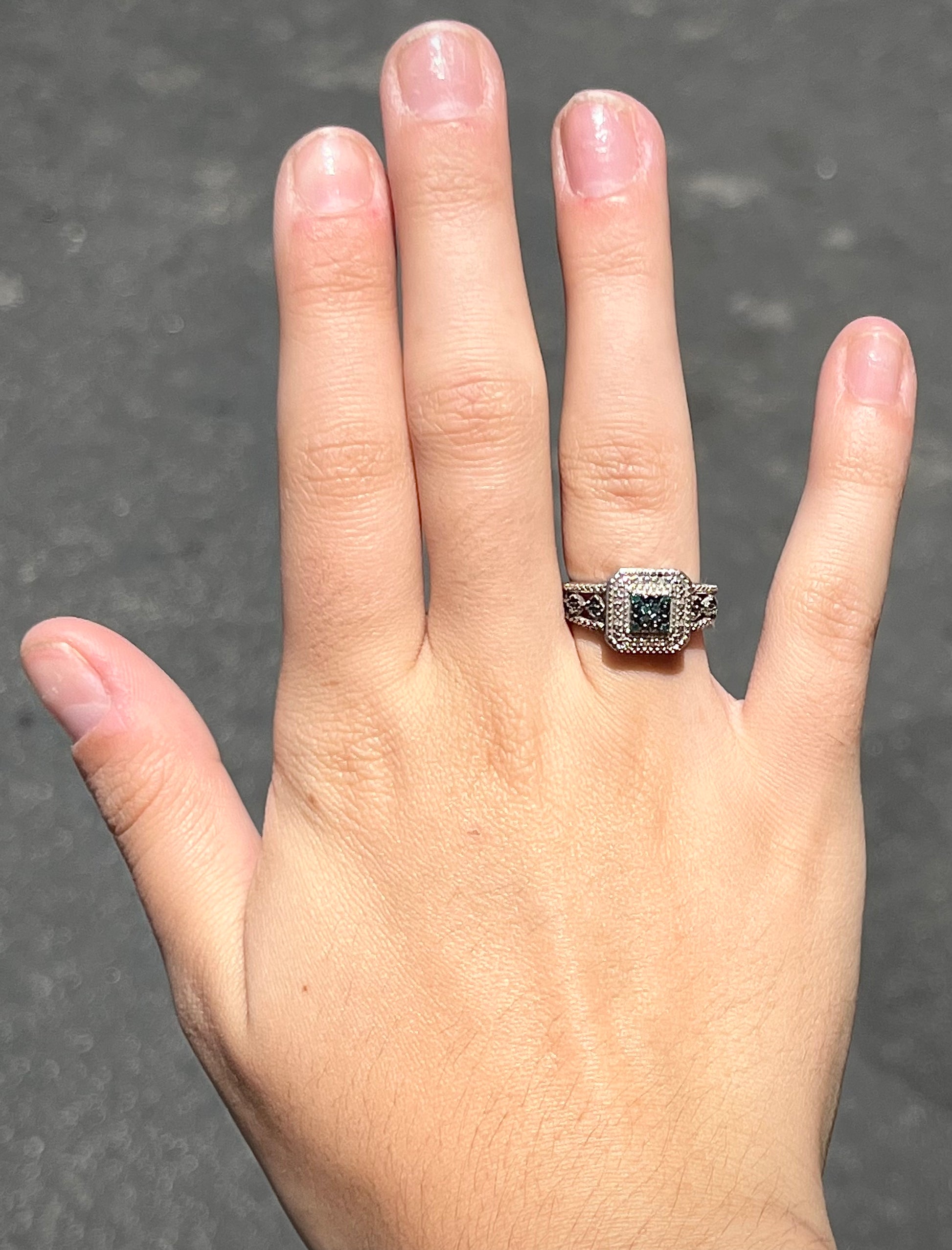 A sterling silver ring set with blue and white diamonds.
