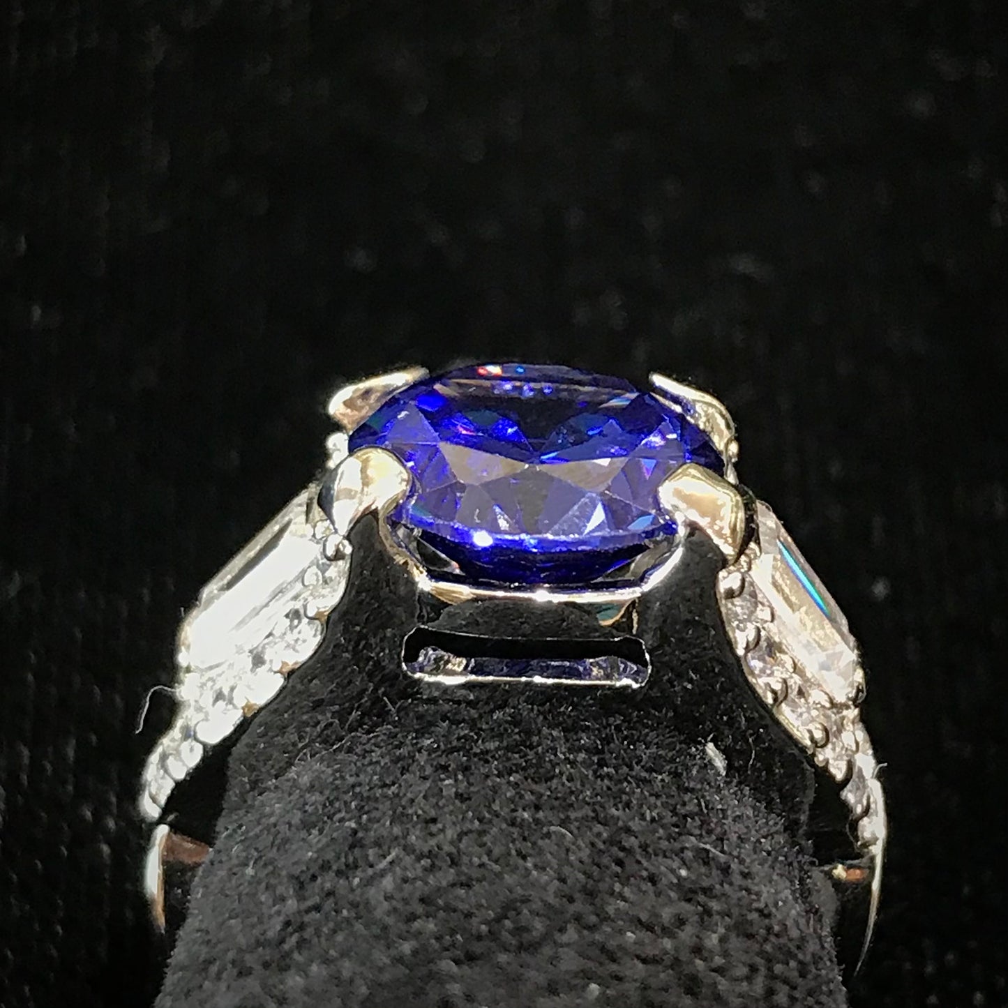 Dark blue synthetic gemstone and cubic zirconia set in sterling silver.