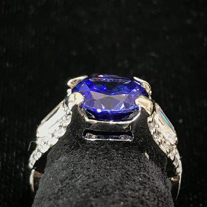 Dark blue synthetic gemstone and cubic zirconia set in sterling silver.