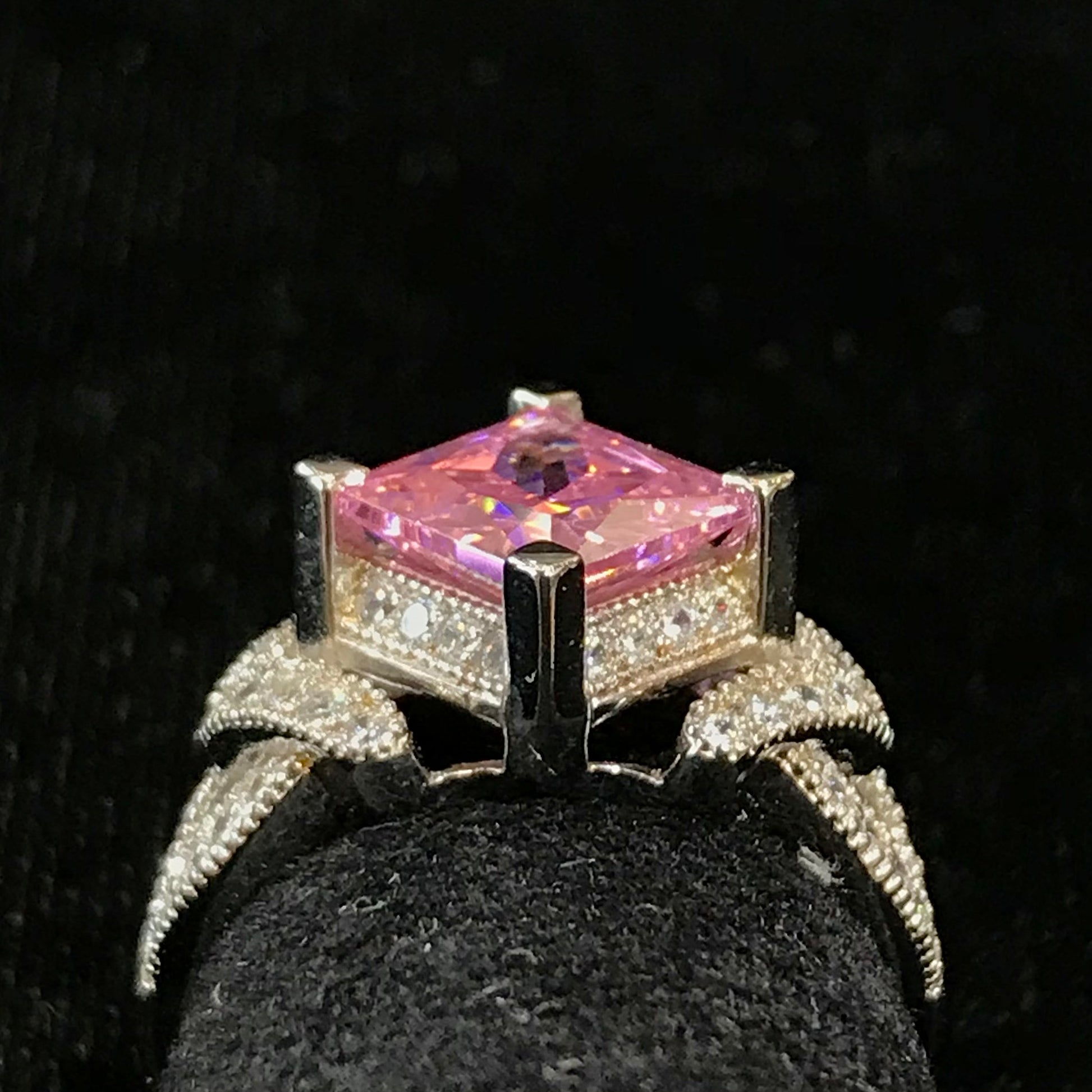 Pink cubic zirconia ring set in sterling silver with white cubic zirconia melee.
