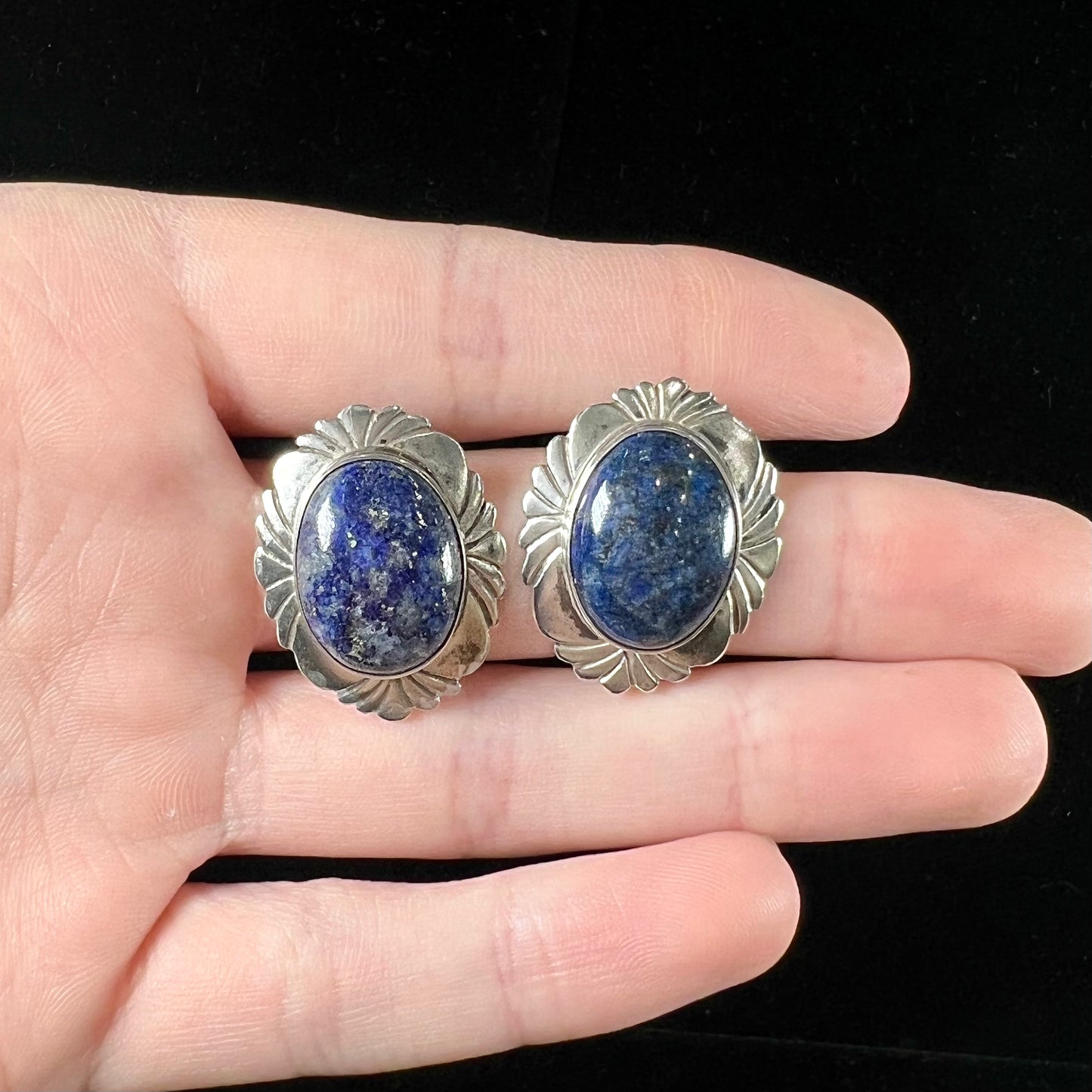 A pair of sterling silver lapis lazuli earrings handmade by Navajo artist, Filbert Brown.